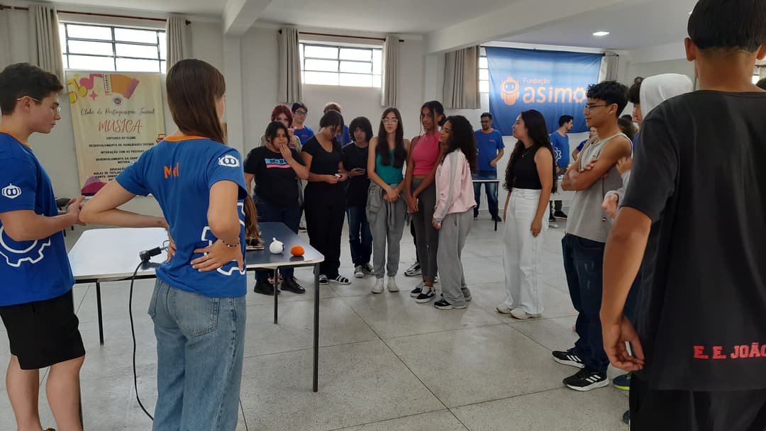 Imagem dos membros da segurando a bandeira da Fundação Asimo